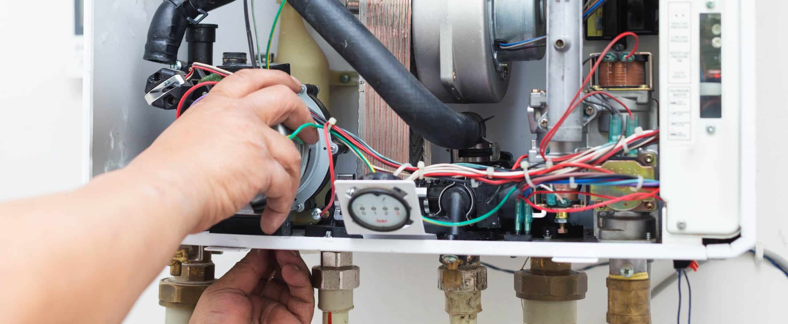 close-up view of electrical components of boiler being repaired